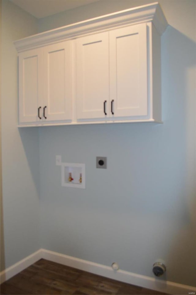 clothes washing area with hookup for an electric dryer, dark hardwood / wood-style flooring, cabinets, gas dryer hookup, and hookup for a washing machine