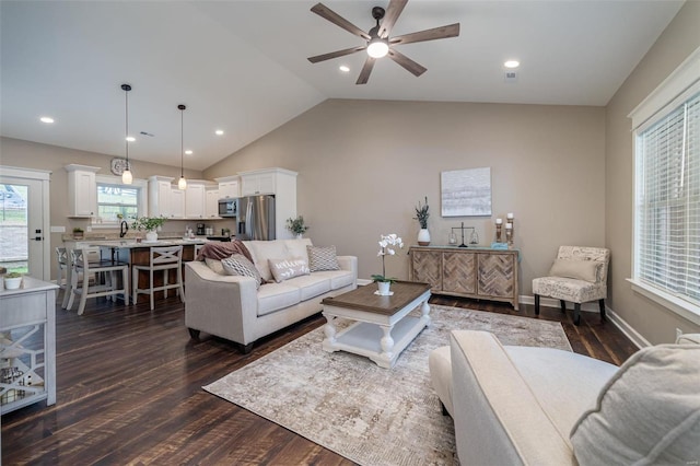 living room with ceiling fan, lofted ceiling, sink, and dark hardwood / wood-style floors