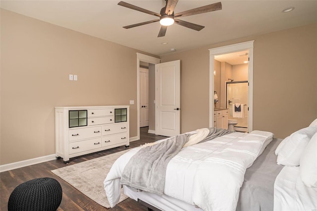 bedroom with dark wood-type flooring, ceiling fan, and ensuite bath