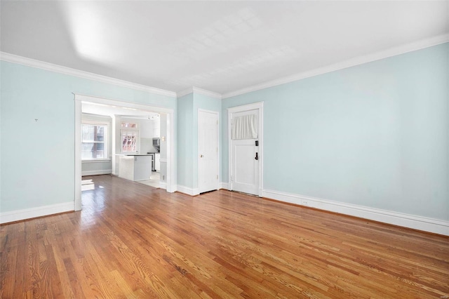 unfurnished room with light hardwood / wood-style floors and crown molding