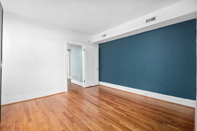 spare room featuring light wood-type flooring