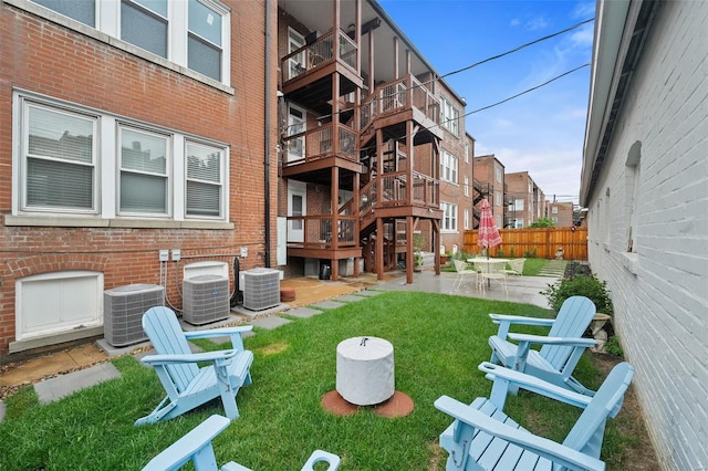 view of yard featuring central AC unit and a patio