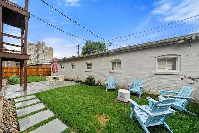 rear view of house with a lawn and a patio area