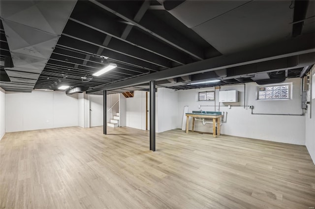 basement with hardwood / wood-style floors