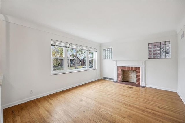 unfurnished living room with a fireplace and wood-type flooring