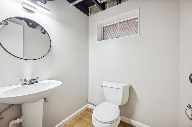 bathroom with hardwood / wood-style floors and toilet