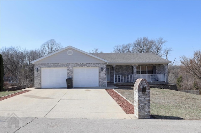 single story home with an attached garage, covered porch, driveway, and a shingled roof