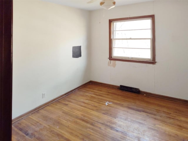 unfurnished room with wood-type flooring