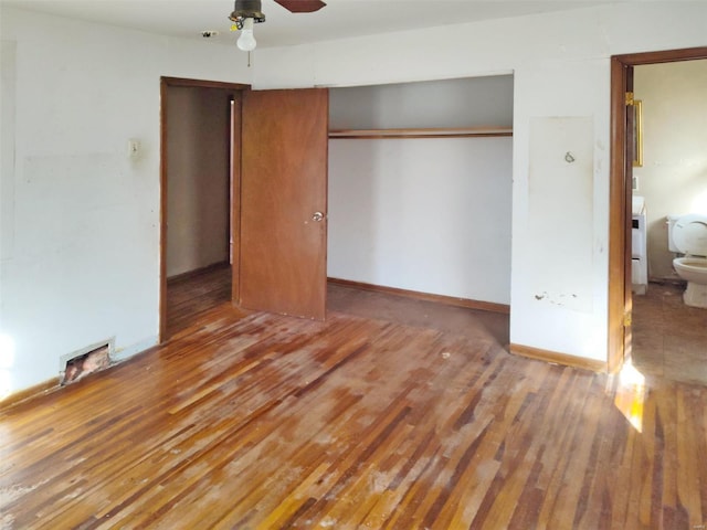 unfurnished bedroom with ensuite bath, wood-type flooring, ceiling fan, and a closet