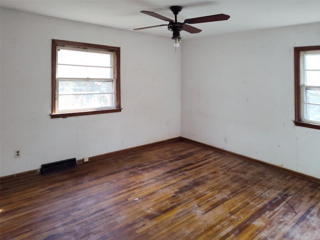 empty room featuring ceiling fan and dark hardwood / wood-style flooring