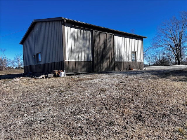 exterior space featuring a pole building, an outdoor structure, and a detached garage