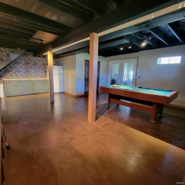 basement with pool table, baseboards, and freestanding refrigerator