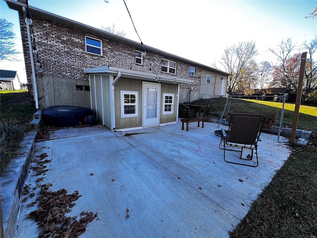 back of property with brick siding and a deck