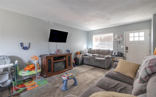 living room featuring light carpet and a textured ceiling