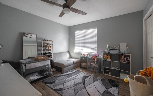 interior space with hardwood / wood-style floors, ceiling fan, and a textured ceiling