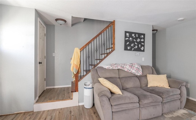 living room with hardwood / wood-style flooring and a textured ceiling