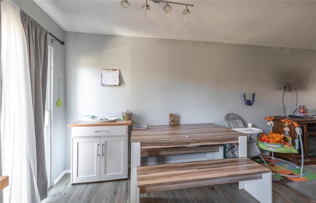 dining area featuring light hardwood / wood-style floors and a textured ceiling