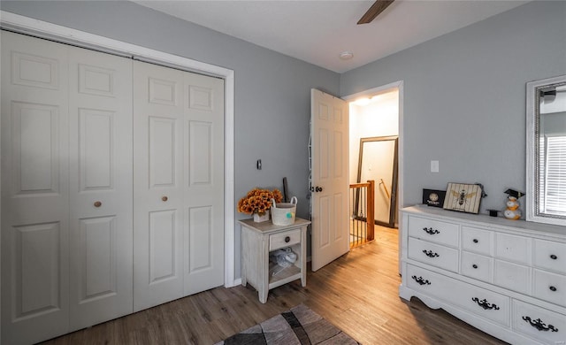 bedroom featuring hardwood / wood-style floors, ceiling fan, and a closet