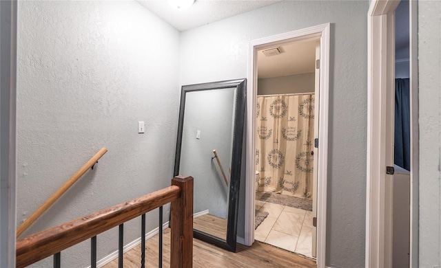 corridor with light hardwood / wood-style floors