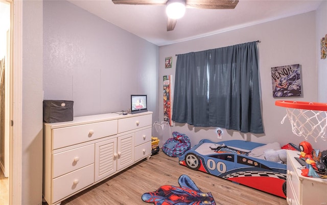 bedroom with light hardwood / wood-style floors and ceiling fan