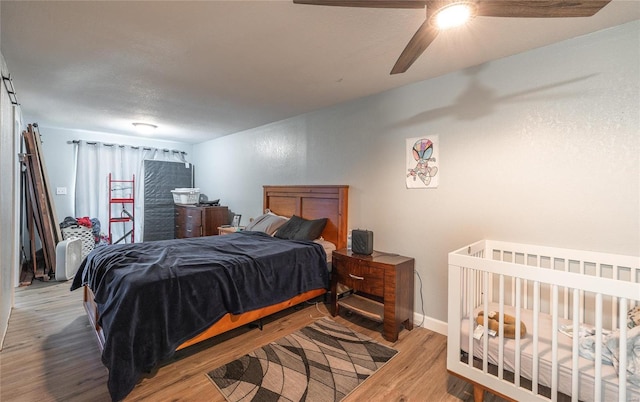 bedroom with wood-type flooring and ceiling fan