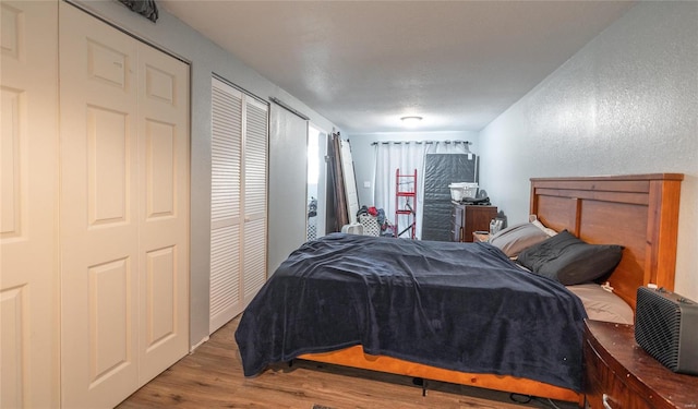 bedroom with hardwood / wood-style flooring and a textured ceiling