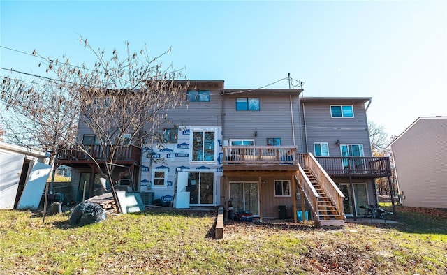 back of property with a lawn and a deck