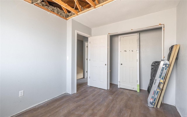 unfurnished bedroom with dark wood-type flooring