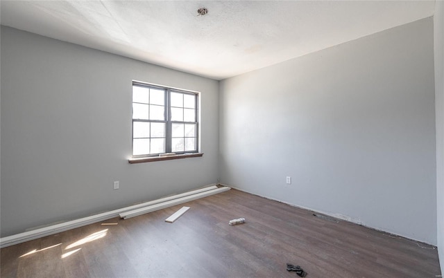 unfurnished room with dark hardwood / wood-style flooring