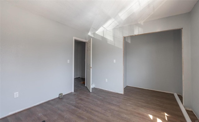 spare room featuring dark hardwood / wood-style flooring