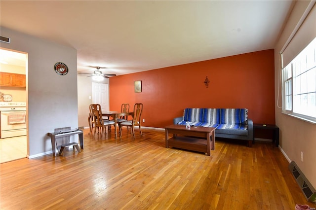 living room with ceiling fan and light hardwood / wood-style floors