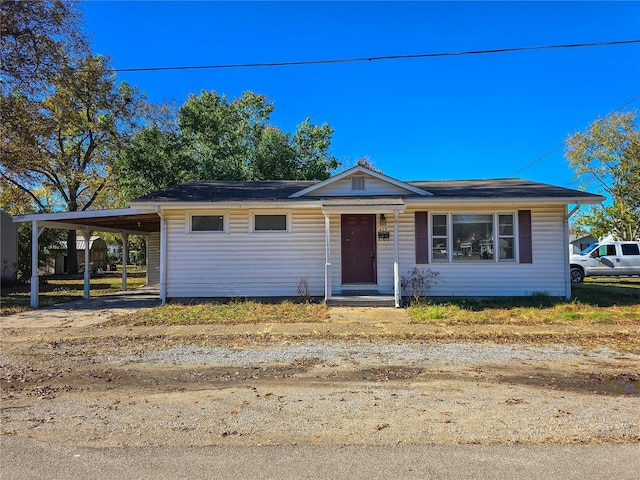 view of front of property featuring a carport