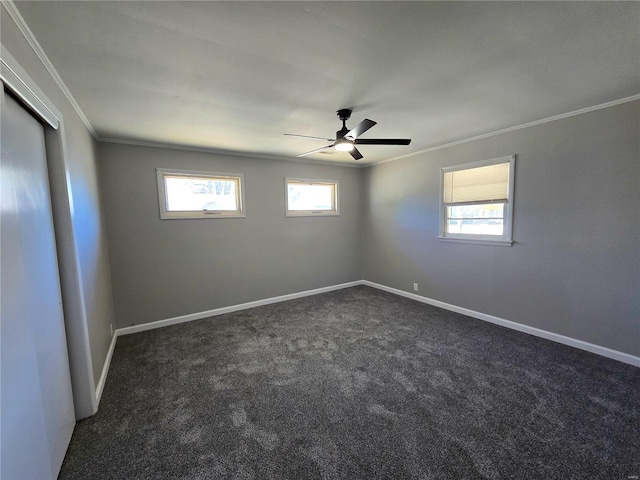 carpeted empty room with ceiling fan and crown molding