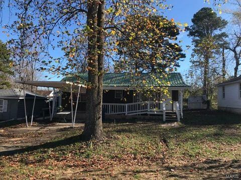 back of property featuring a carport