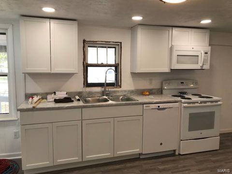 kitchen featuring dark wood-type flooring, white appliances, white cabinetry, and sink