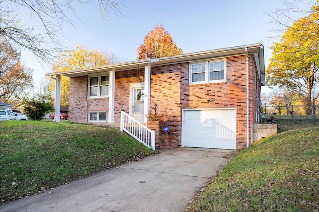 raised ranch with a garage and a front lawn