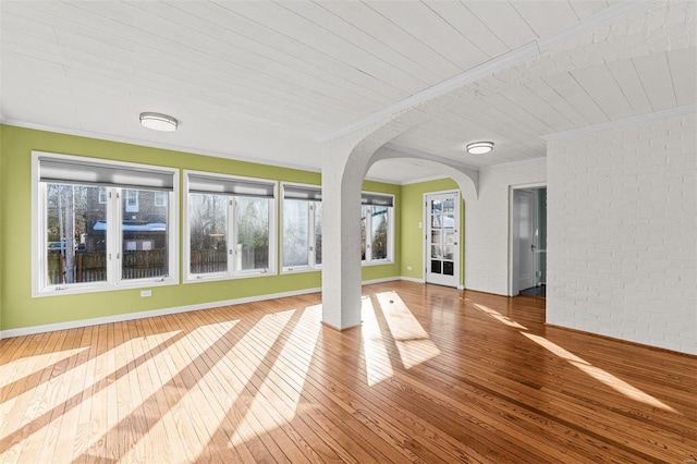 unfurnished sunroom with wooden ceiling and a wealth of natural light