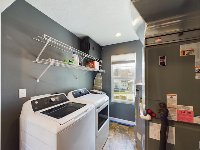 laundry room featuring heating unit and washing machine and dryer