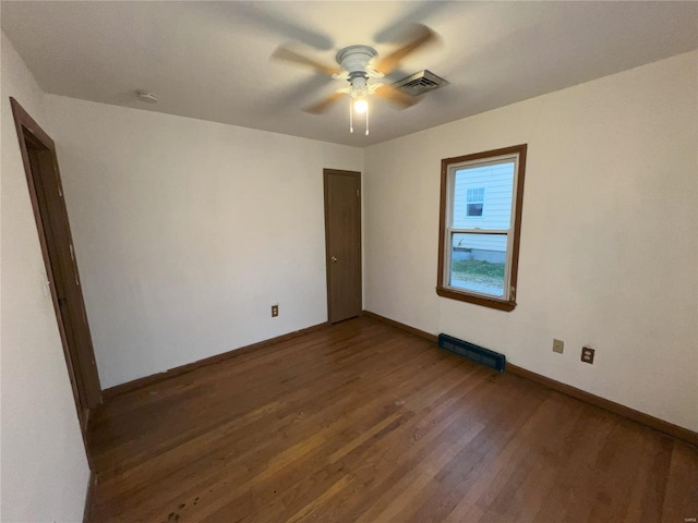 spare room featuring dark hardwood / wood-style flooring and ceiling fan