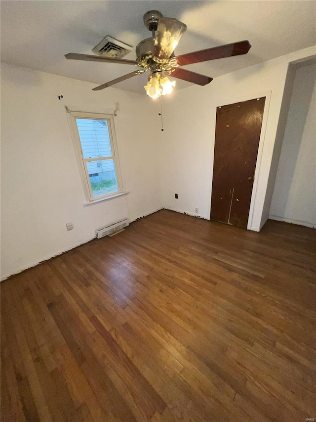 unfurnished bedroom with ceiling fan and dark wood-type flooring