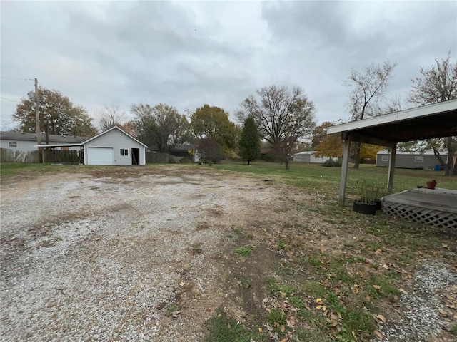 view of yard featuring a garage and an outdoor structure