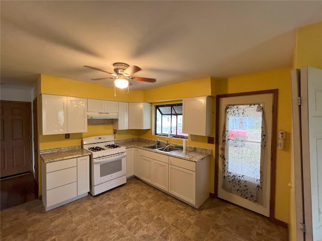 kitchen featuring white gas range oven, white cabinetry, ceiling fan, and sink