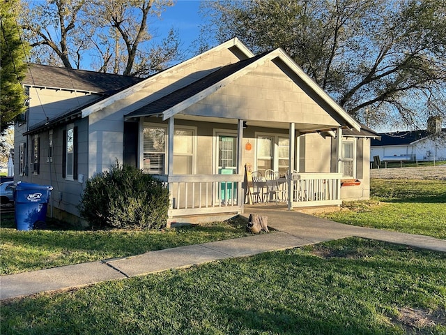 bungalow-style house with a porch and a front yard