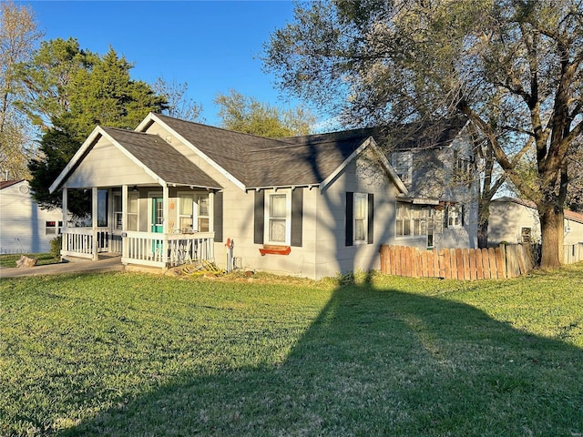 ranch-style home with covered porch and a front yard