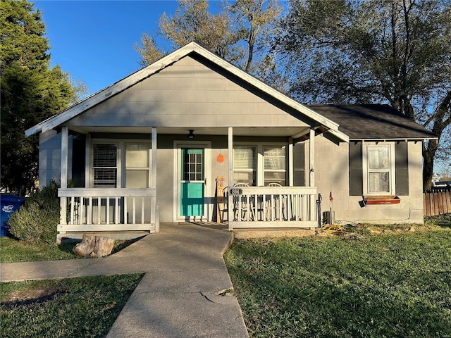 bungalow-style house featuring a porch and a front lawn