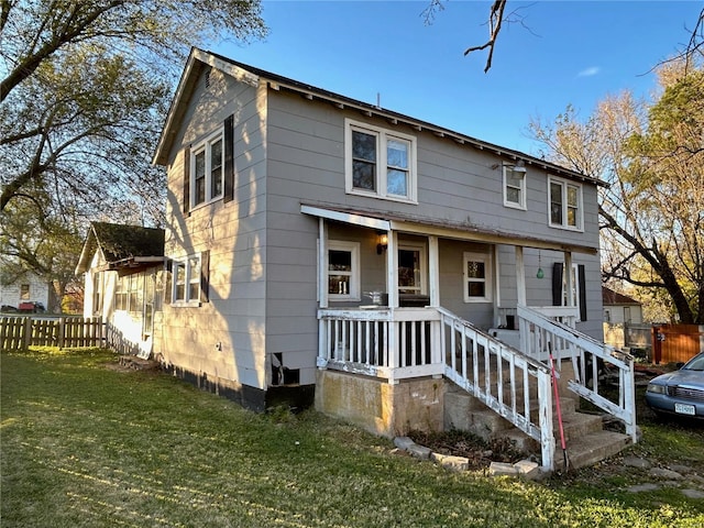 view of front of home featuring a front yard and a porch