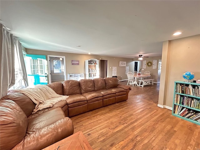 living room with hardwood / wood-style flooring and ceiling fan