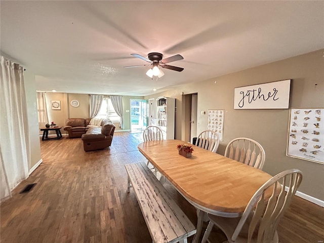 dining room with dark hardwood / wood-style flooring and ceiling fan