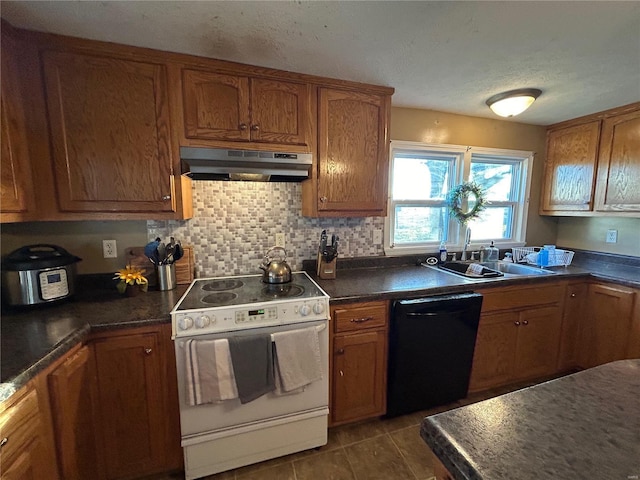 kitchen with dishwasher, sink, tasteful backsplash, white range, and dark tile patterned flooring