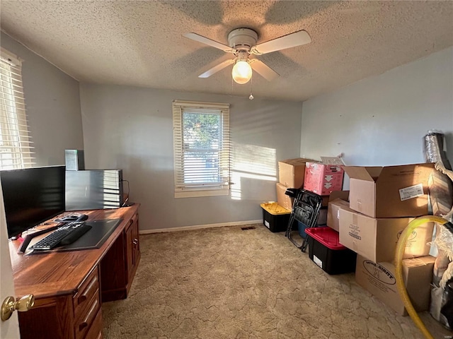 office featuring a textured ceiling, light colored carpet, and ceiling fan